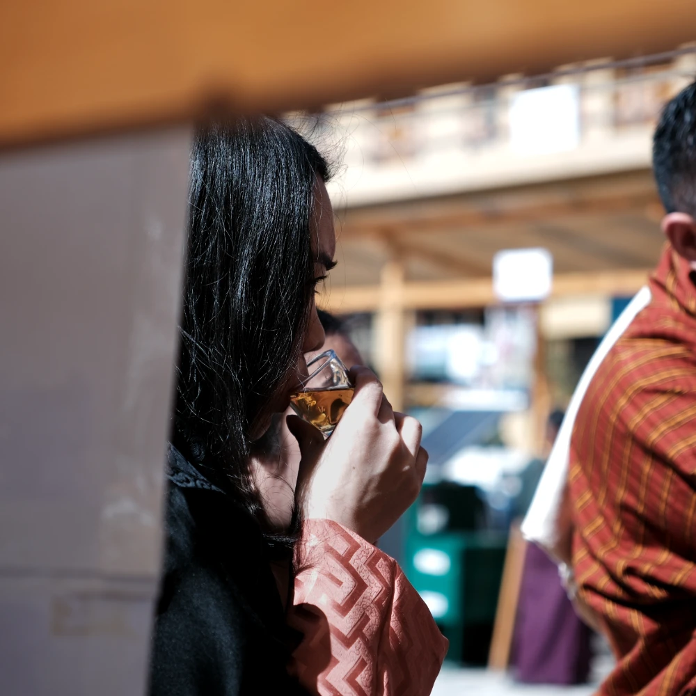 A woman drinking a natural and authentic premium tea produced in Bhutan.